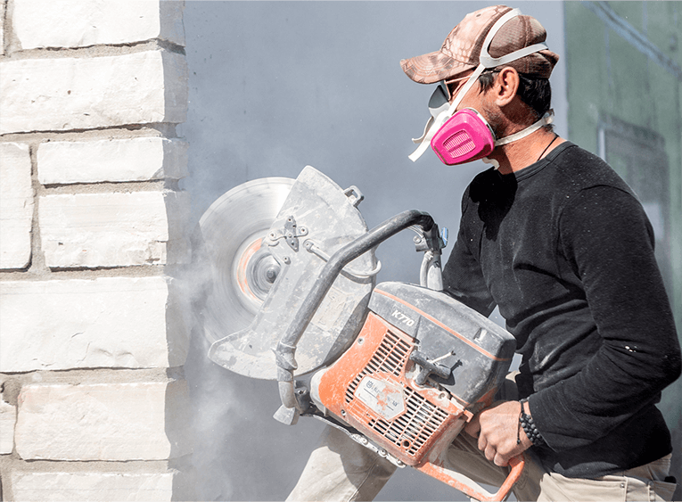 man repairing a wall with an angle grinder